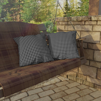 Black and white checkered outdoor pillow — spun polyester, UV and water resistant