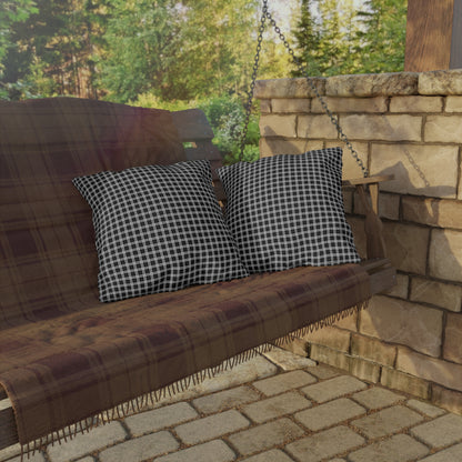 Black and white checkered outdoor pillow — spun polyester, UV and water resistant