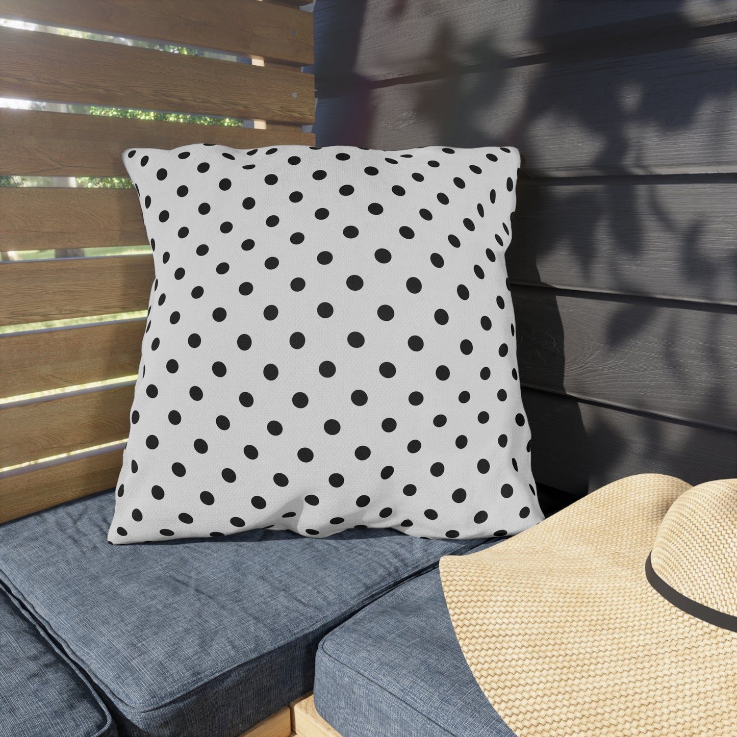 Black and white polka dot outdoor pillow — spun polyester, UV and water resistant