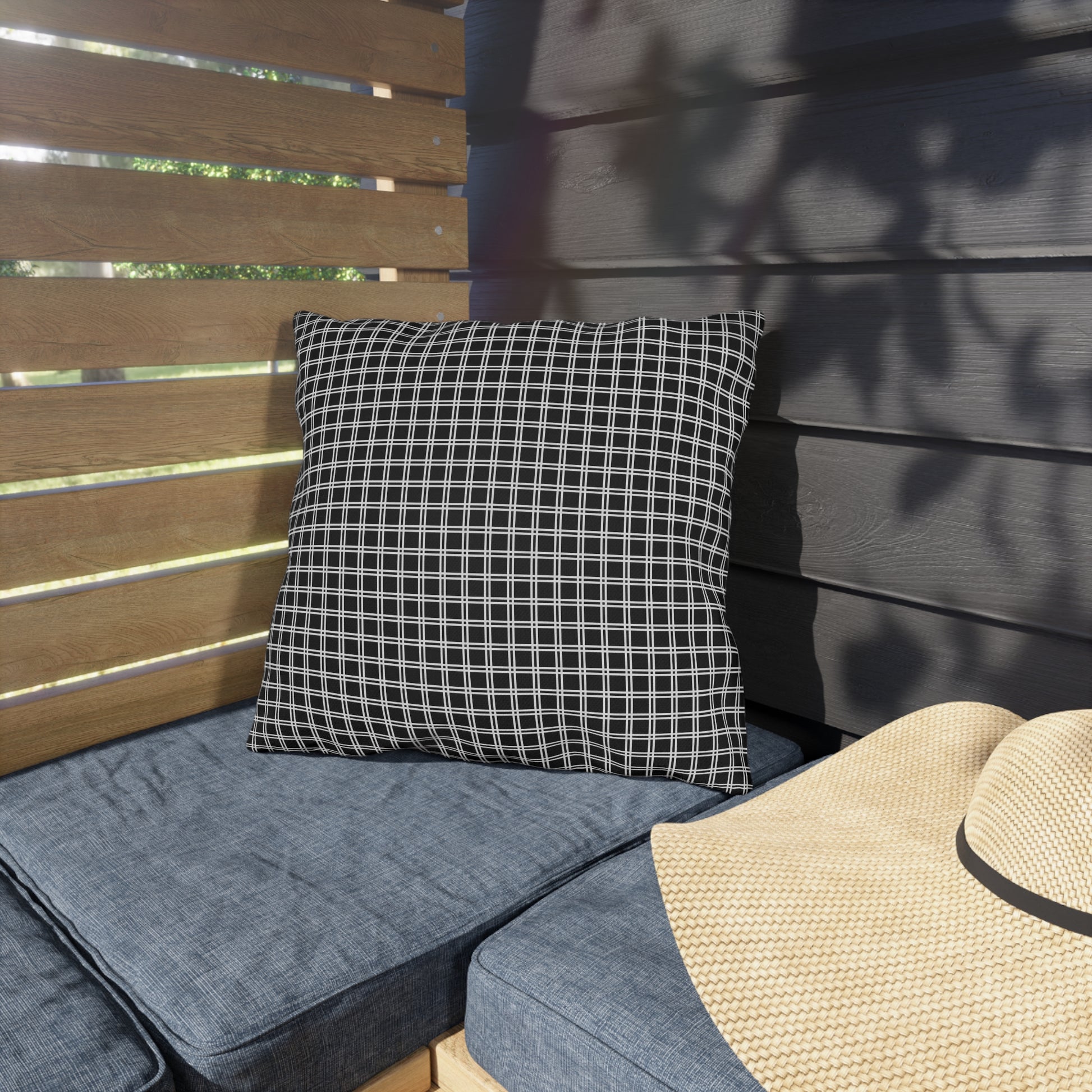 Black and white checkered outdoor pillow — spun polyester, UV and water resistant