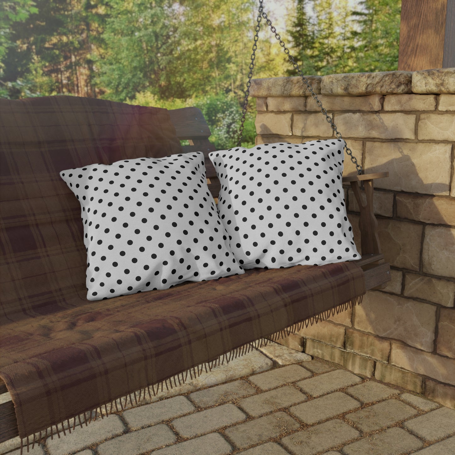 Black and white polka dot outdoor pillow — spun polyester, UV and water resistant