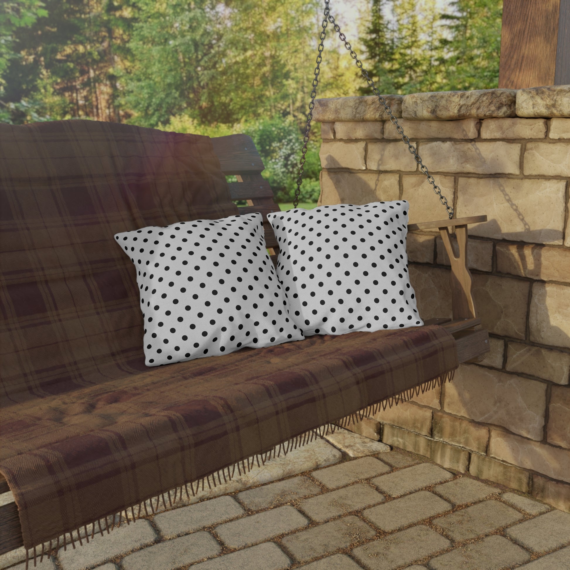Black and white polka dot outdoor pillow — spun polyester, UV and water resistant