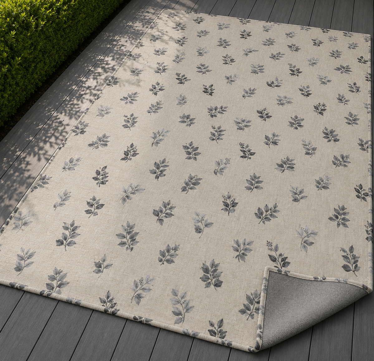 Charcoal leaf sprig outdoor rug — soft polyester chenille with a non-slip backing