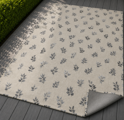 Charcoal leaf sprig outdoor rug — soft polyester chenille with a non-slip backing