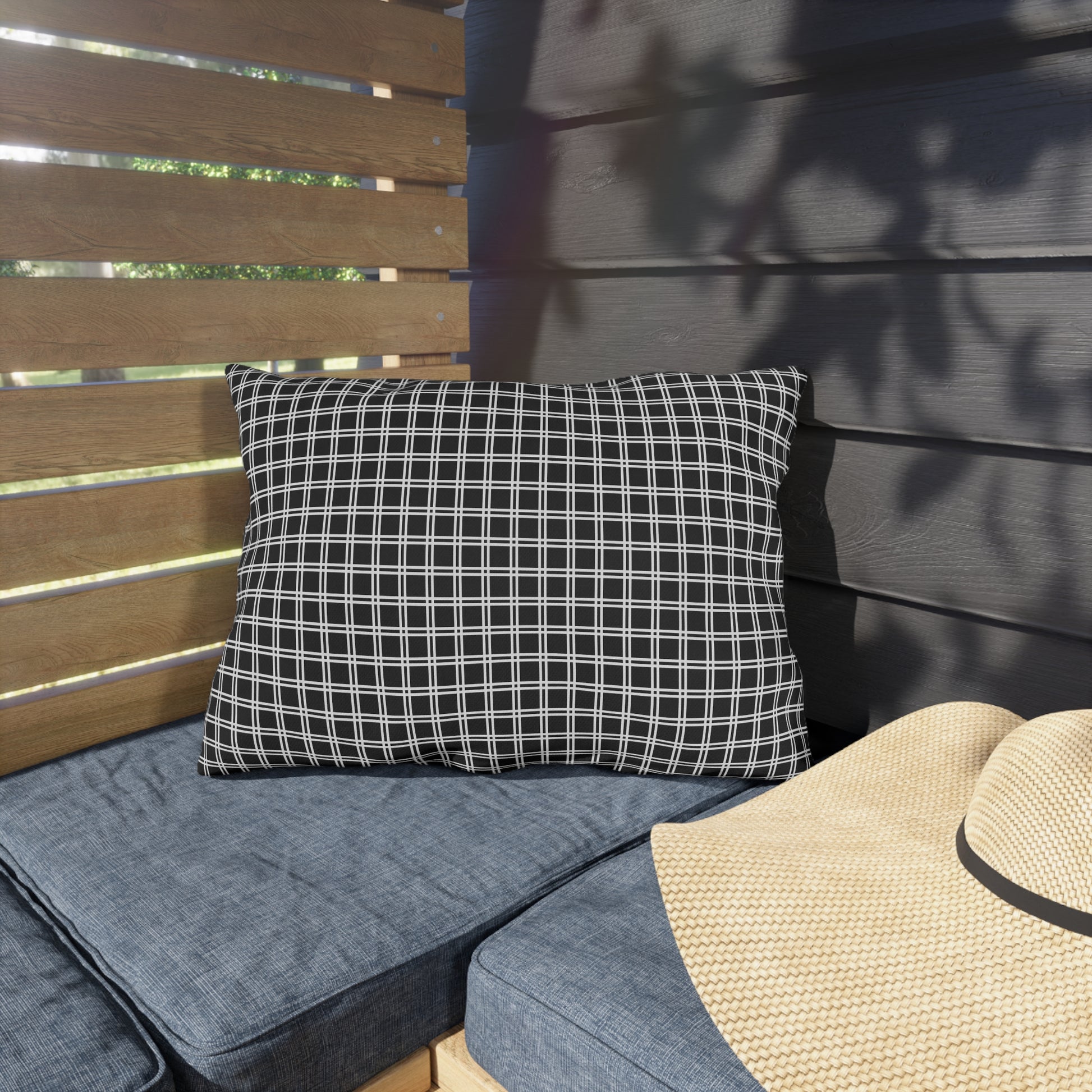 Black and white checkered lumbar outdoor pillow — spun polyester, UV and water resistant