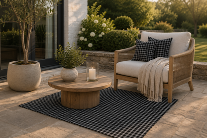 Black and white checkered outdoor rug in a patio setting — soft polyester chenille with a non-slip backing
