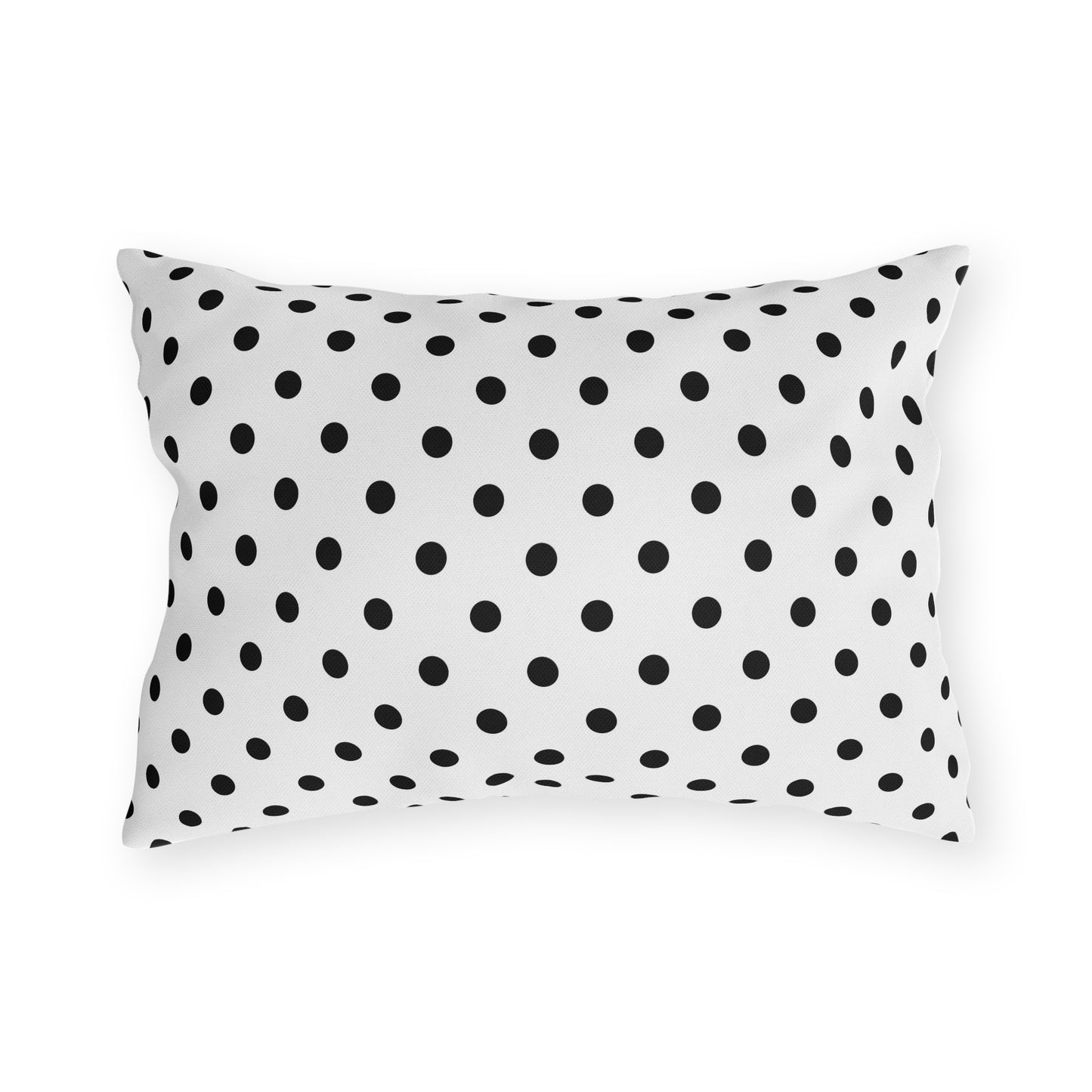 Black and white polka dot lumbar outdoor pillow — spun polyester, UV and water resistant