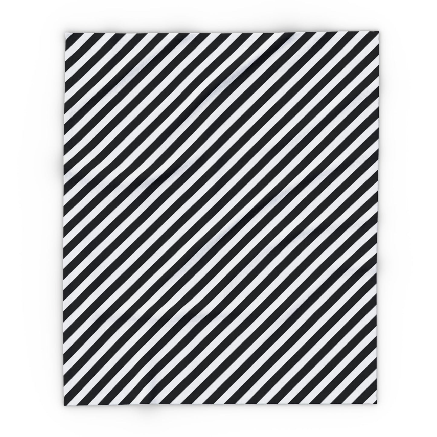 Black and white striped outdoor fleece blanket draped over a chair on a patio