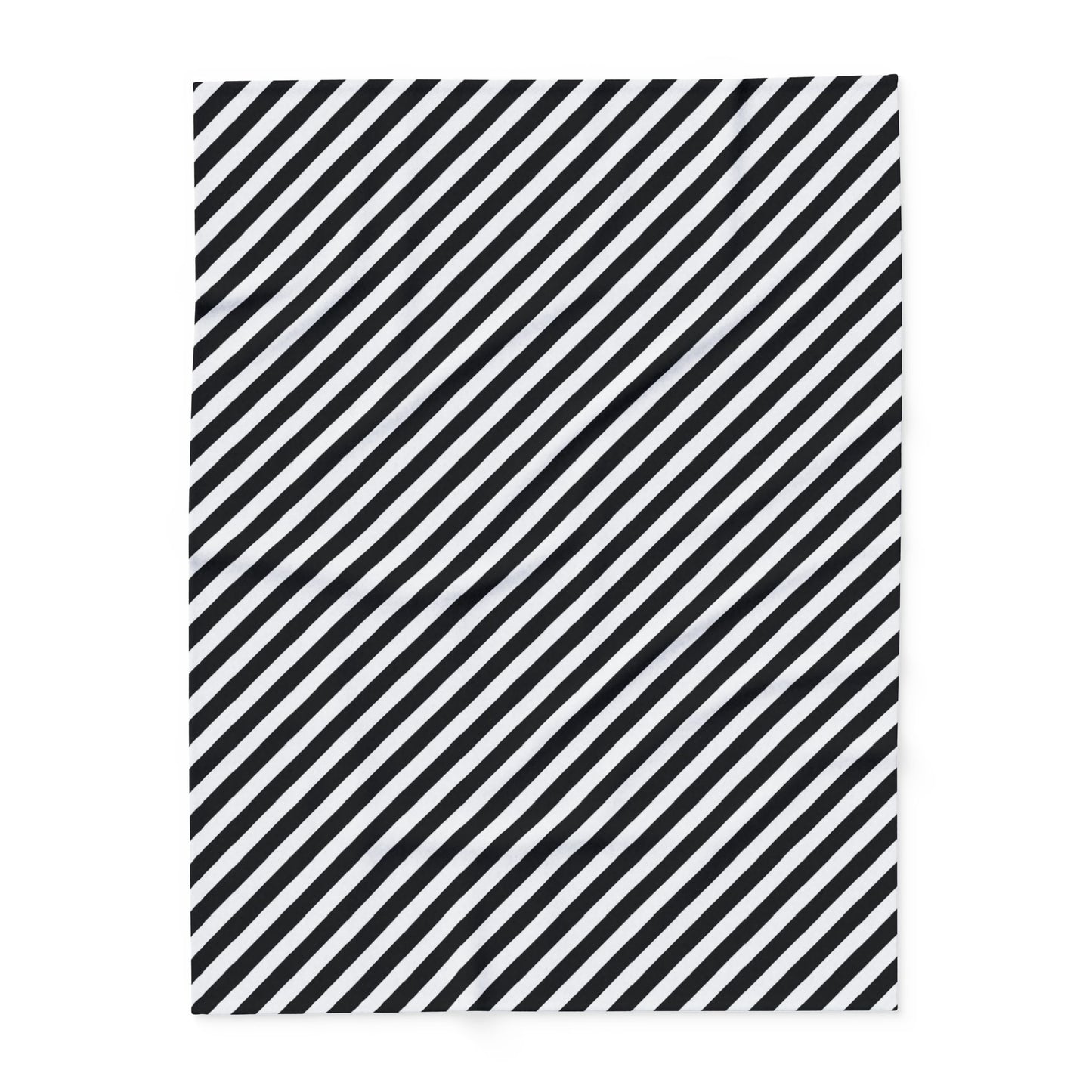 Close-up of the diagonal stripe print and hemmed edge on the black and white fleece blanket