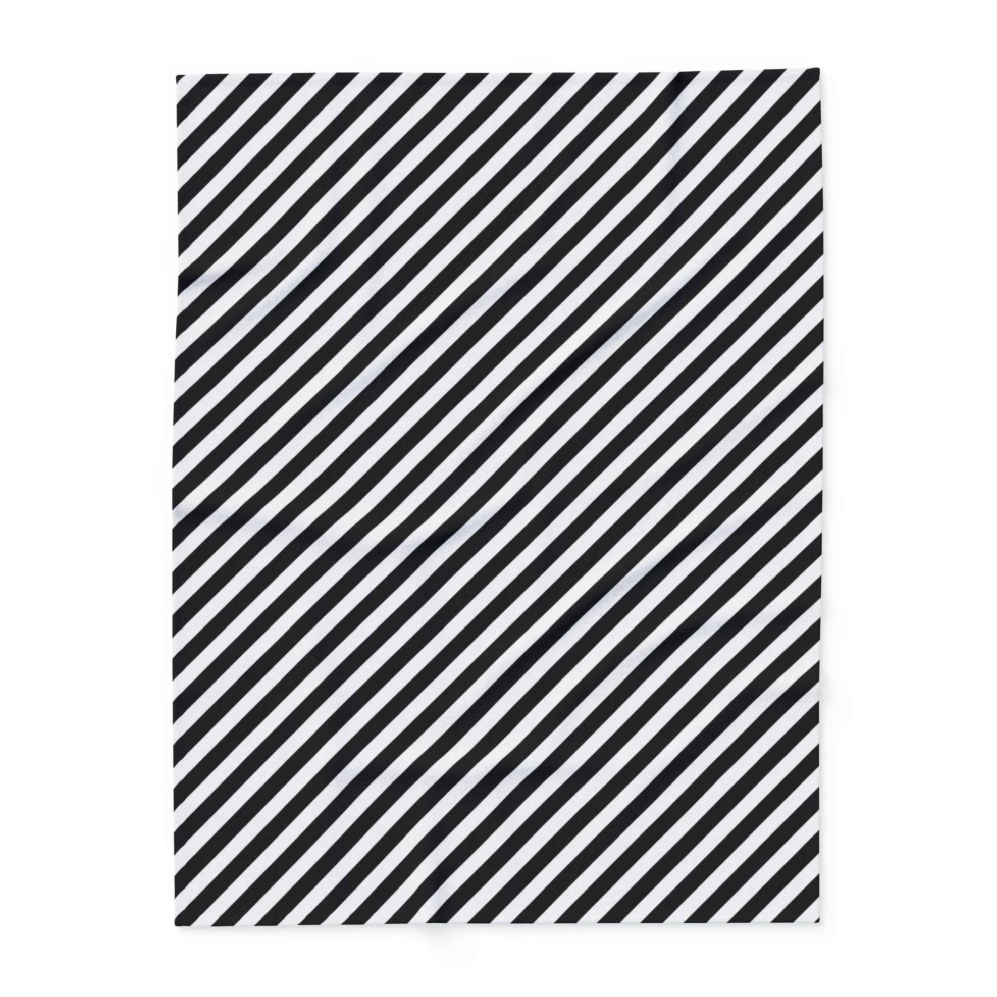Close-up of the diagonal stripe print and hemmed edge on the black and white fleece blanket