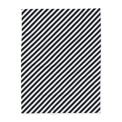 Close-up of the diagonal stripe print and hemmed edge on the black and white fleece blanket