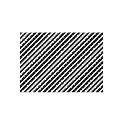 Black and white striped outdoor rug shown in all four sizes, 24x36 to 60x84