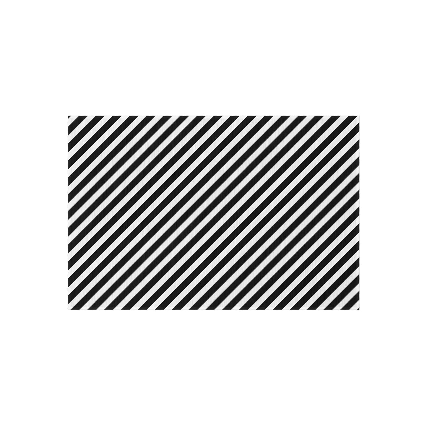 Black and white diagonal striped outdoor rug on a patio — soft polyester chenille with non-slip backing