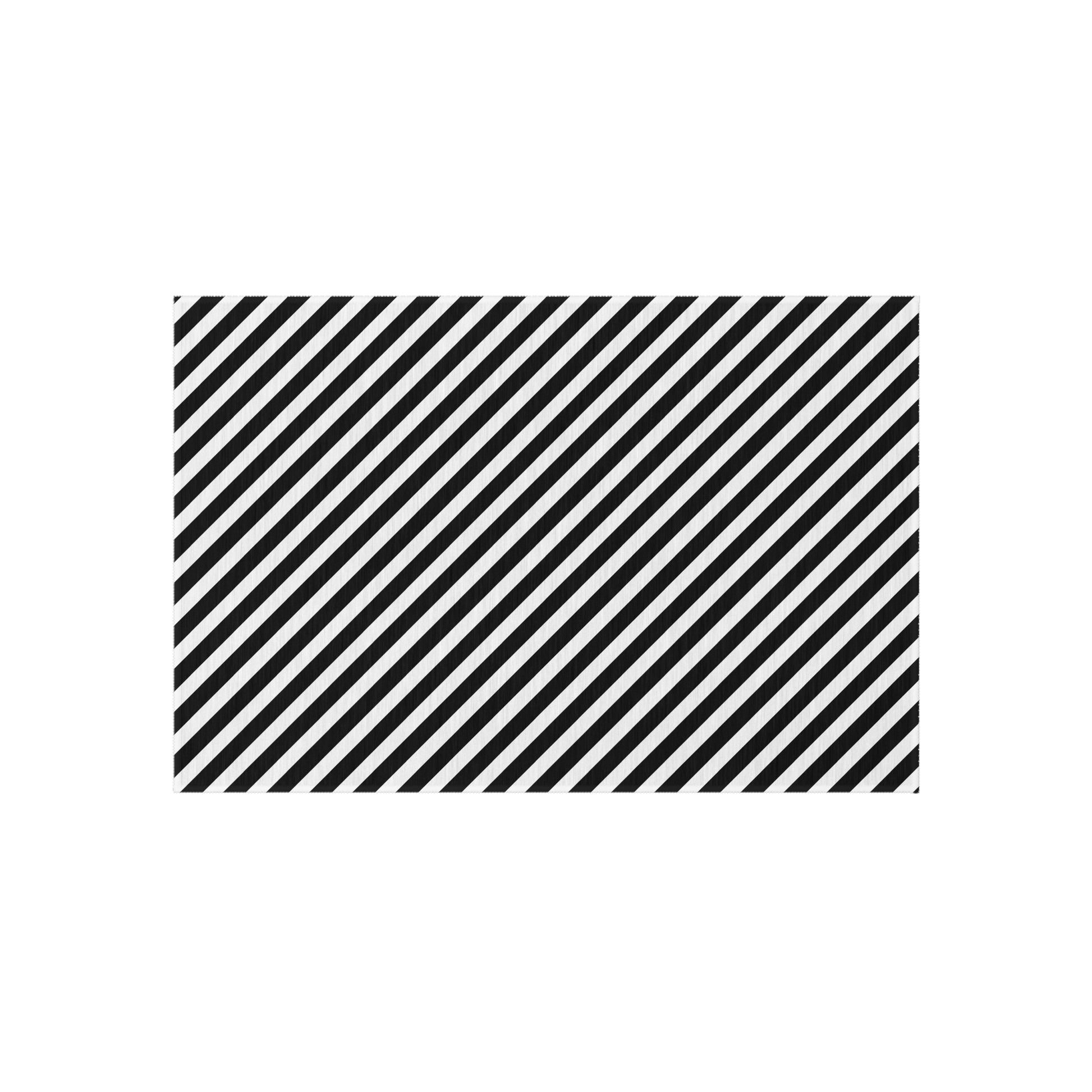 Black and white diagonal striped outdoor rug on a patio — soft polyester chenille with non-slip backing