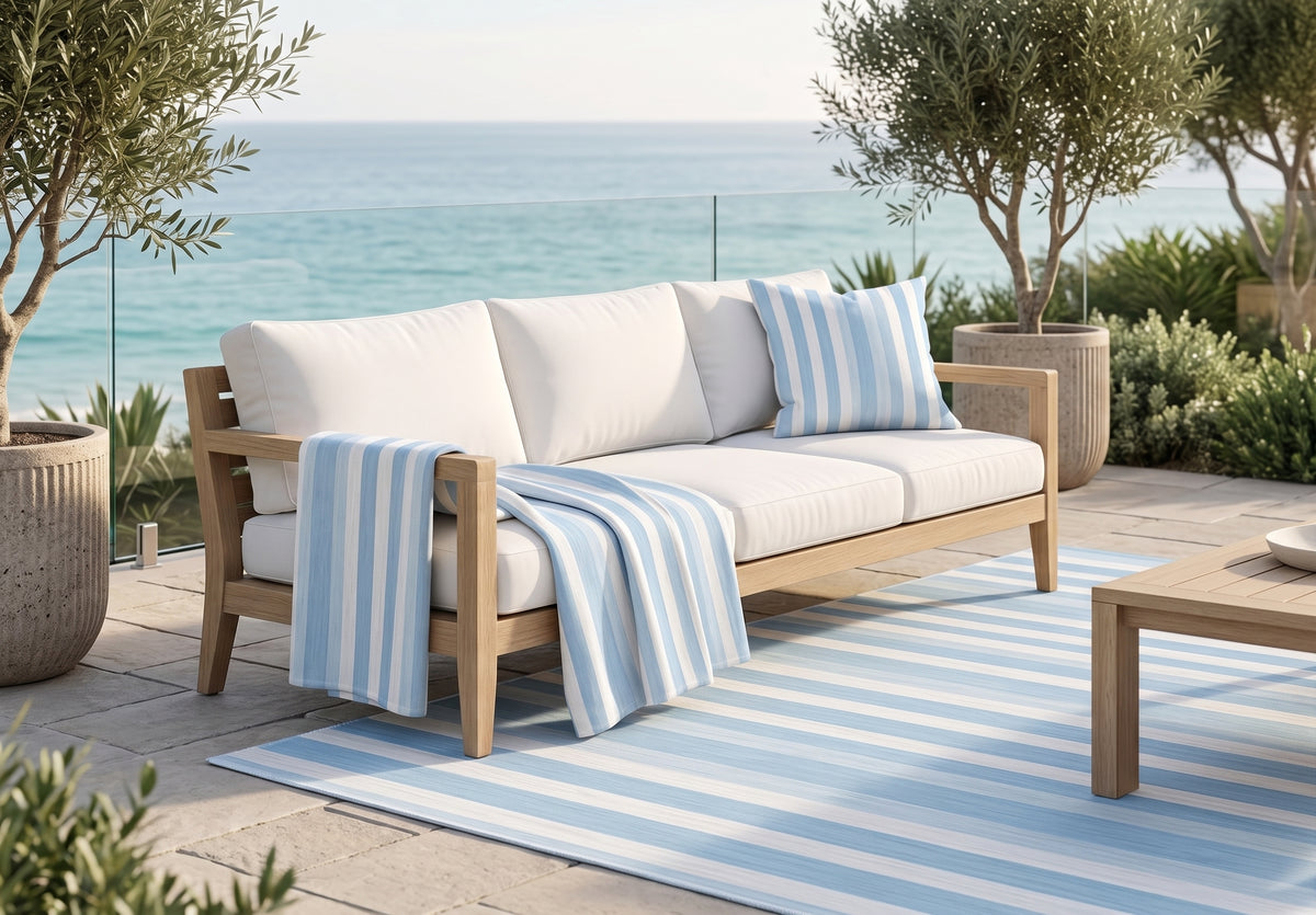 Blue and white striped outdoor pillow — spun polyester, UV and water resistant