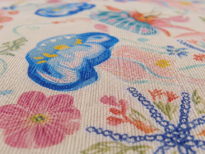 Macro close-up of the coastal seashell outdoor rug surface — fine chenille weave