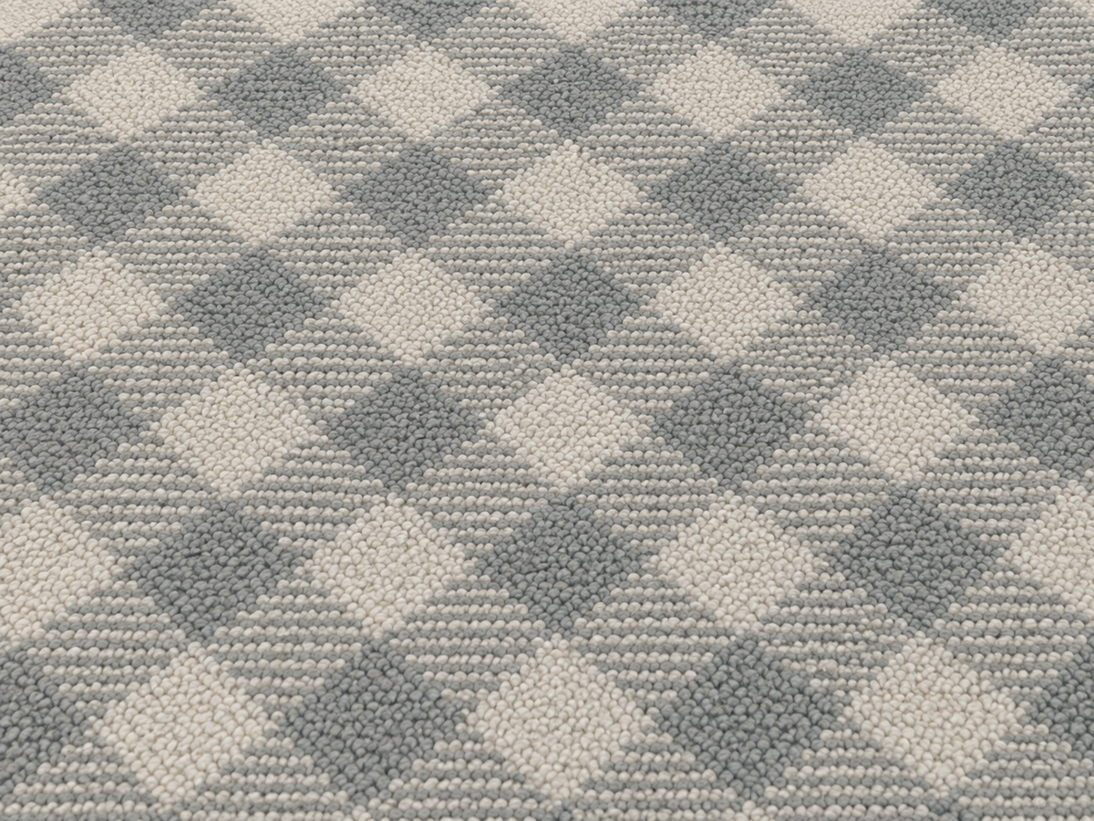Close-up of the grey diagonal gingham outdoor rug — short, dense low-pile chenille nap