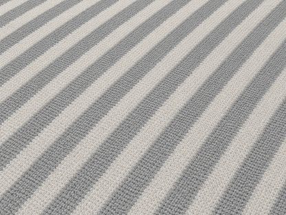 Close-up of the grey diagonal stripe outdoor rug — short, dense low-pile chenille nap