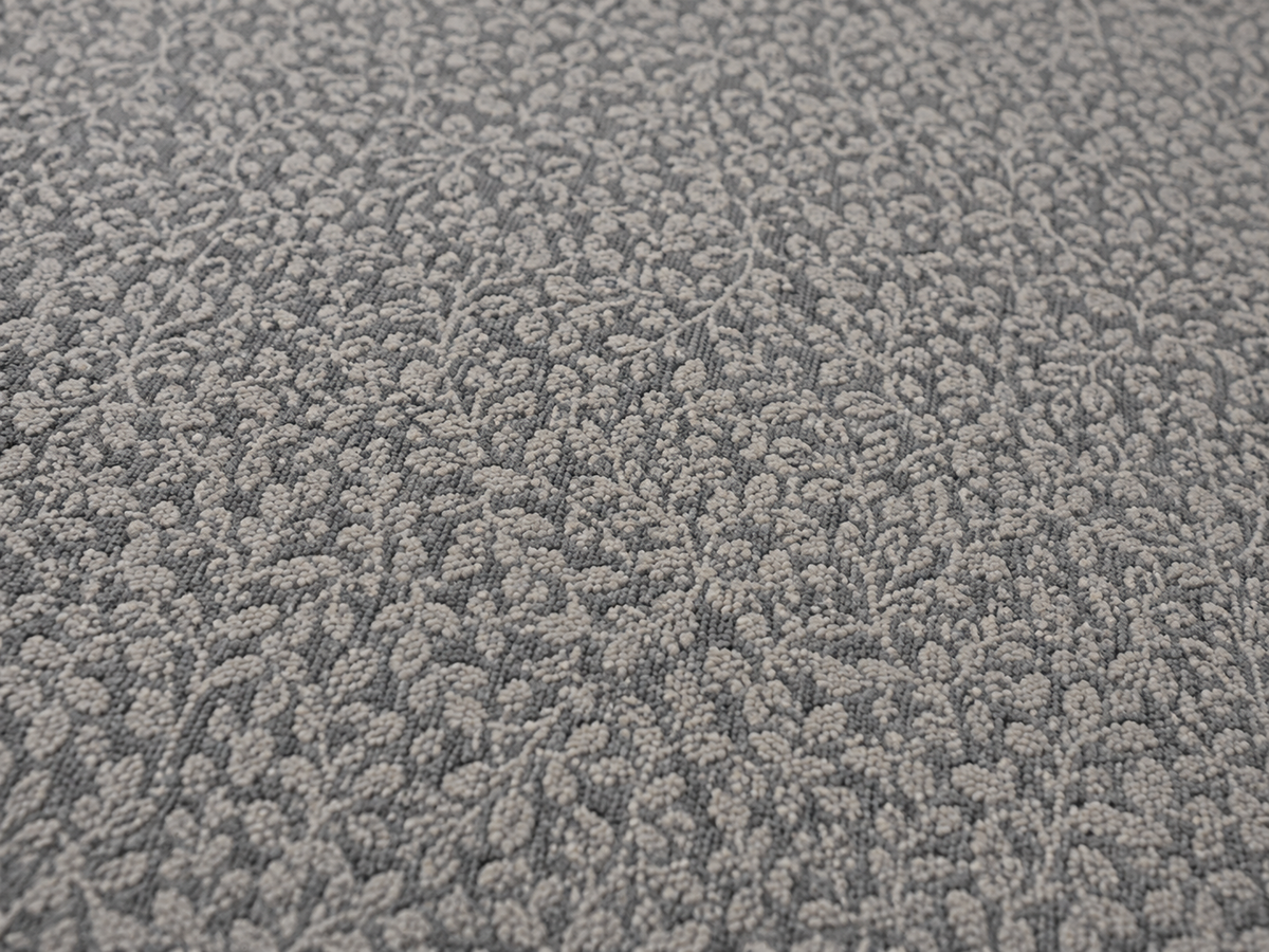 Close-up of the grey foliage outdoor rug — short, dense low-pile chenille nap