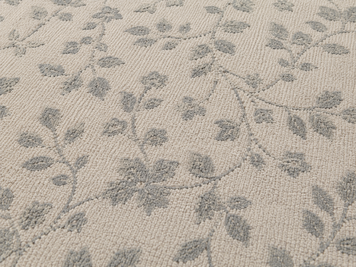 Close-up of the grey trailing vine outdoor rug — short, dense low-pile chenille nap