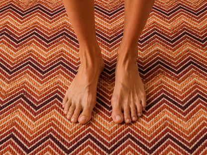 Rust chevron outdoor rug — soft polyester chenille with a non-slip backing