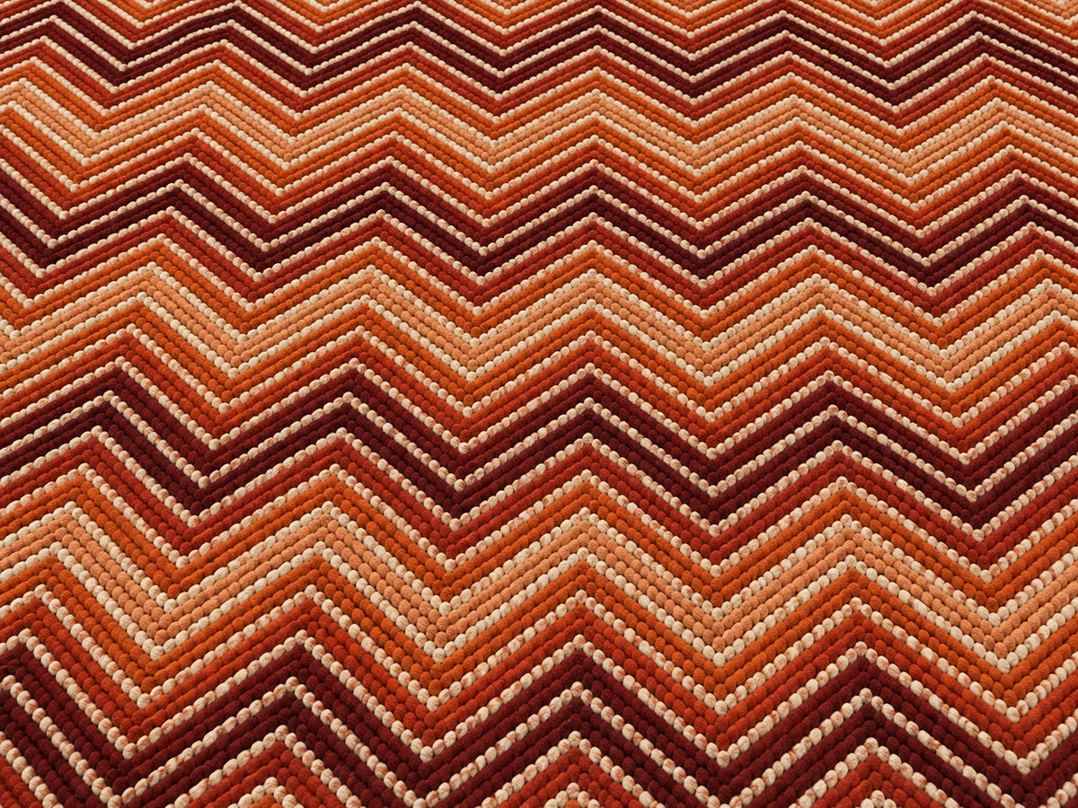 Rust chevron outdoor rug — soft polyester chenille with a non-slip backing
