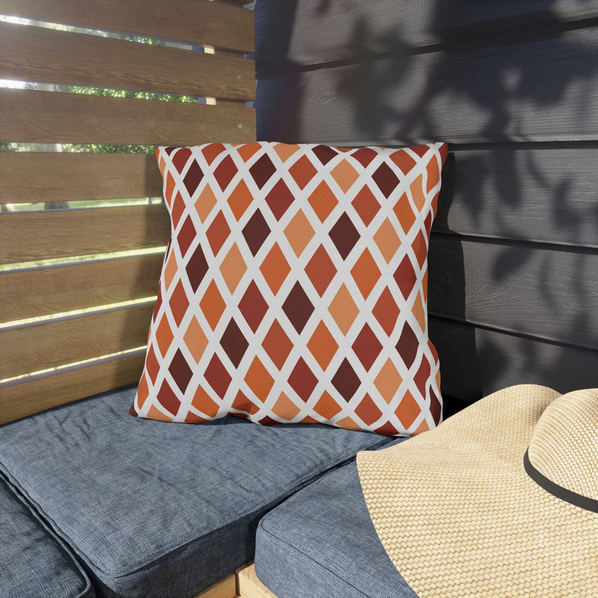 Rust harlequin diamond outdoor pillow — spun polyester, UV and water resistant